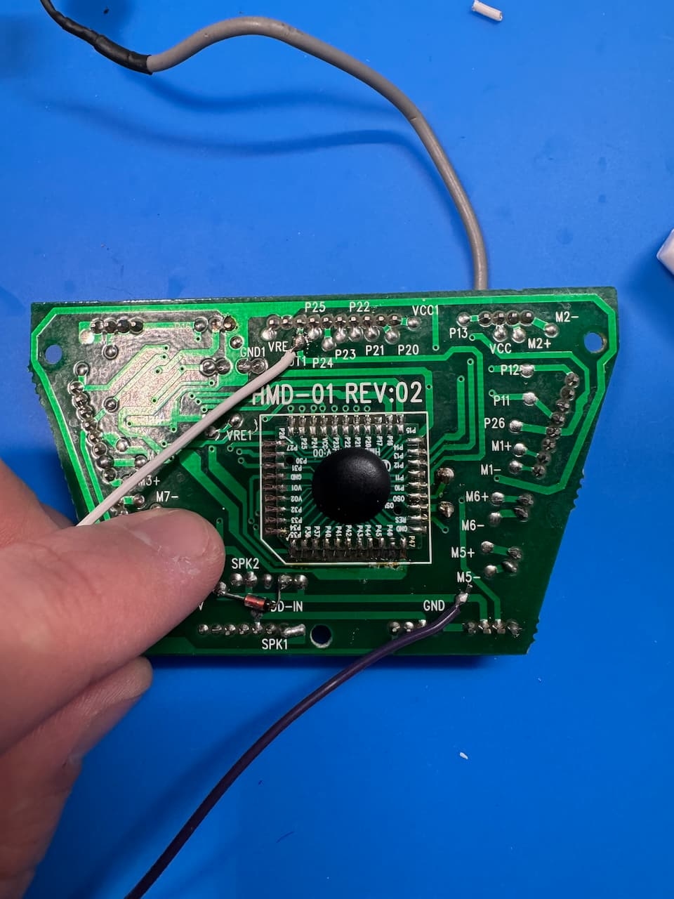 The board inside the robot with the two wires soldered