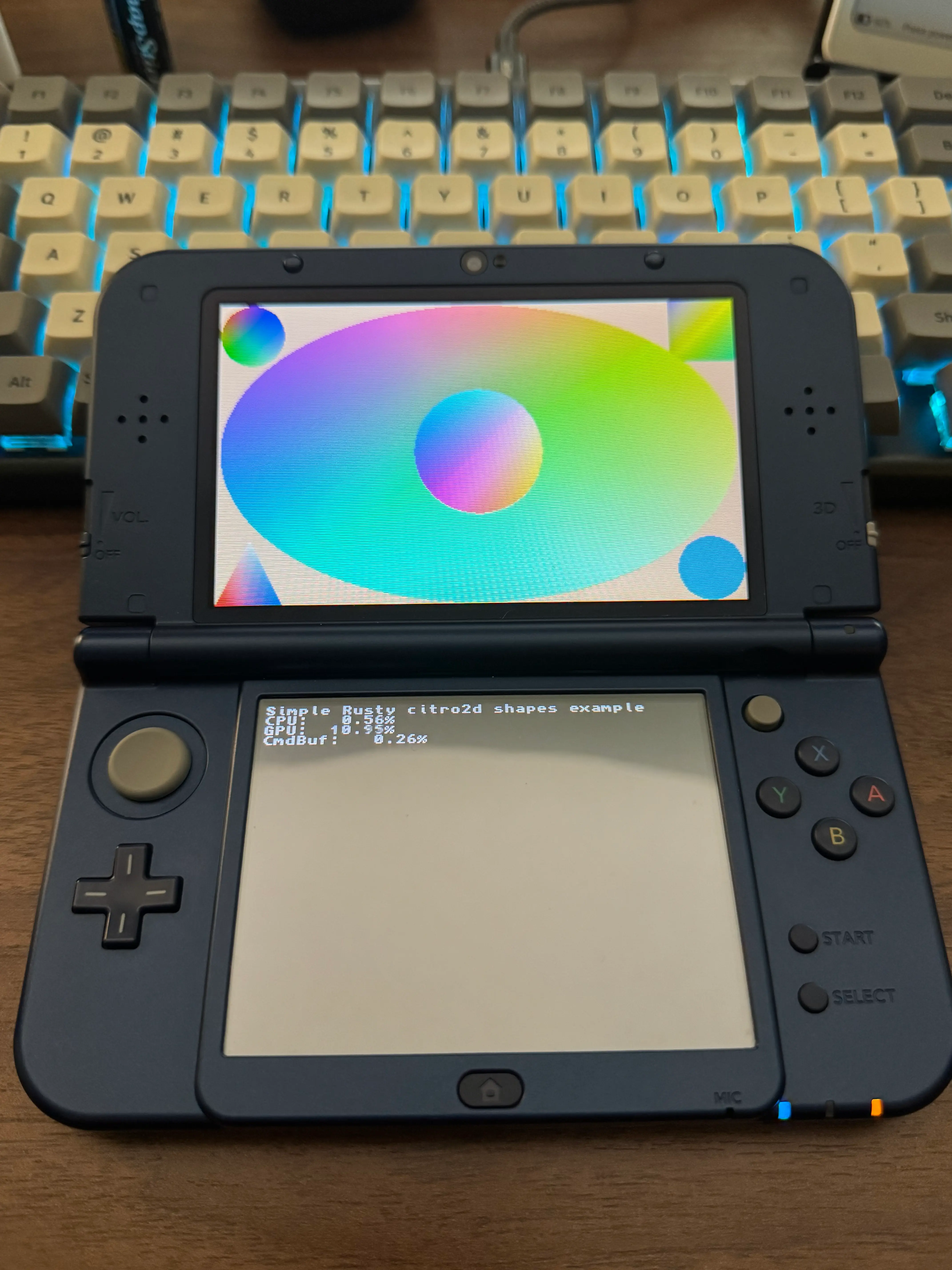 A picture of a 3DS showing the 2d_shapes demo