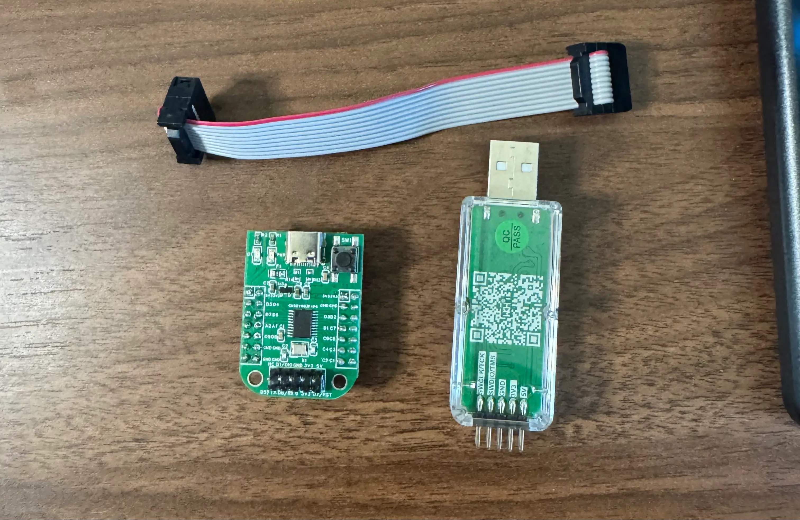 The dev board, WCH-LinkE, and ribbon cable laid out