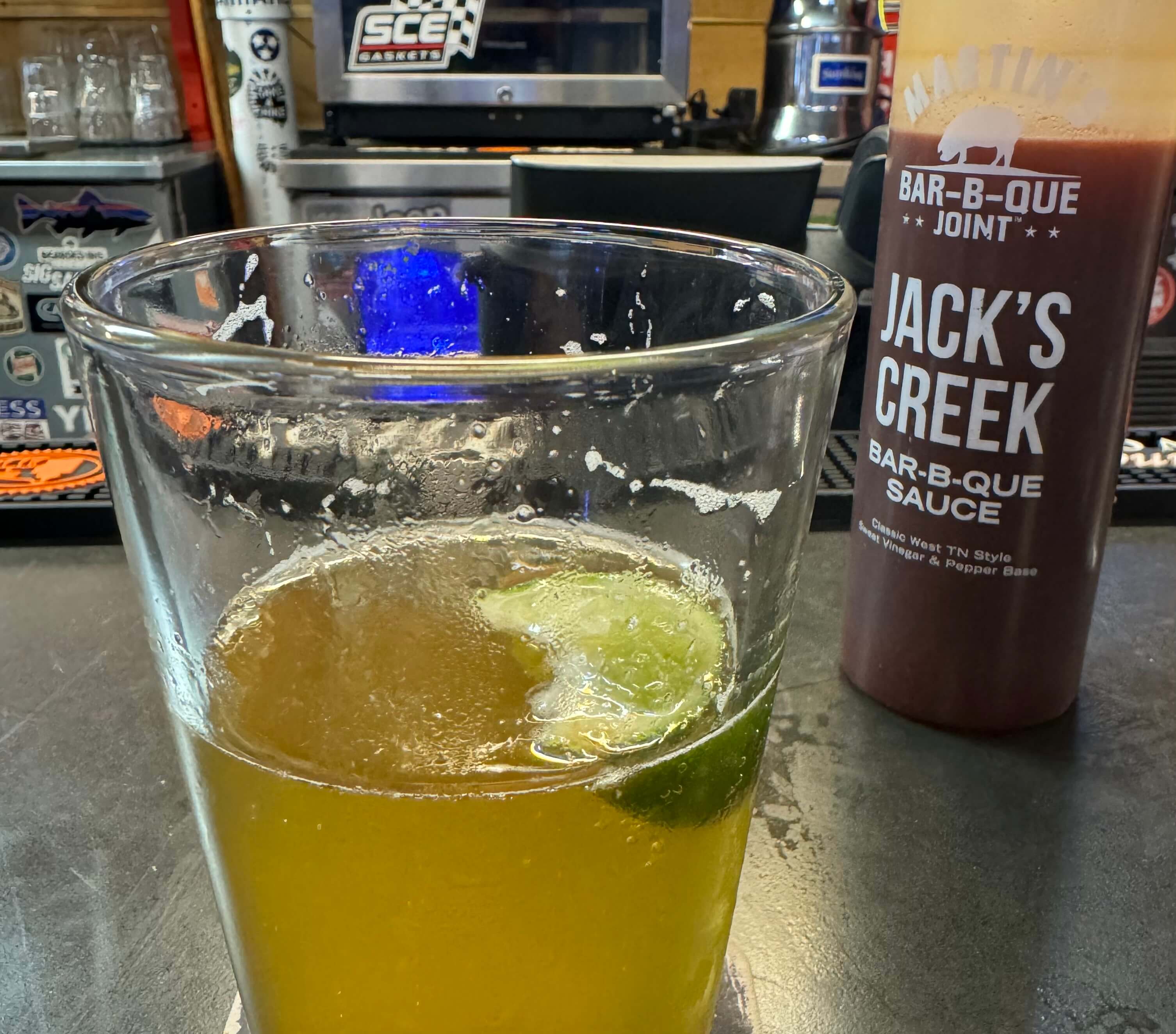 A photo of a bar with a beer and a phone on the table